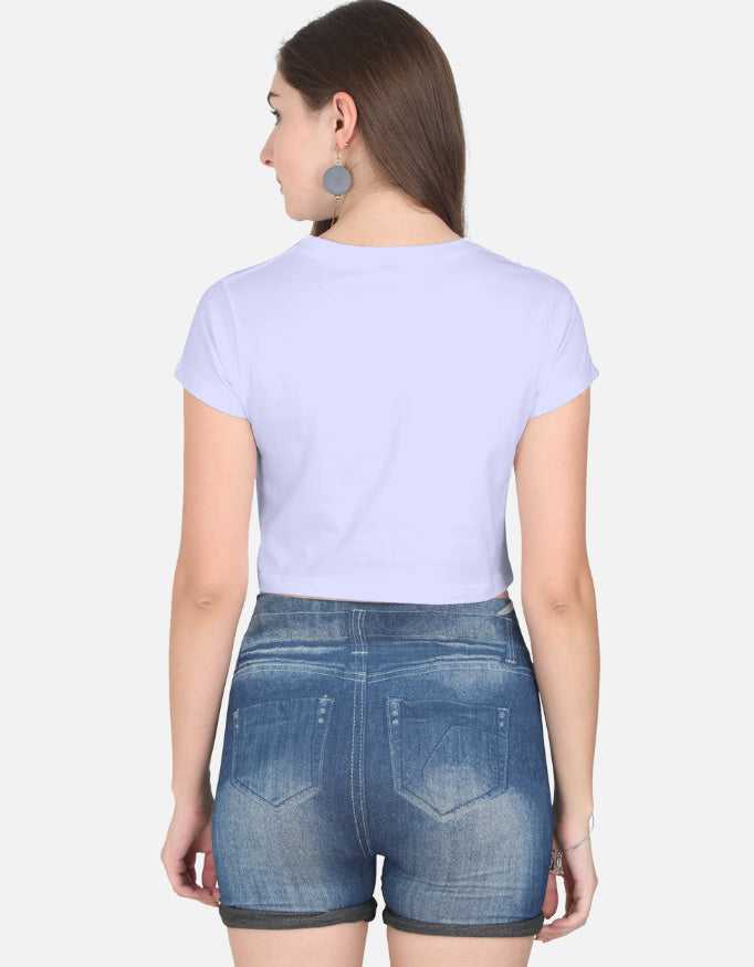 Back view of women wearing lavender crop top with denim shorts and large earrings