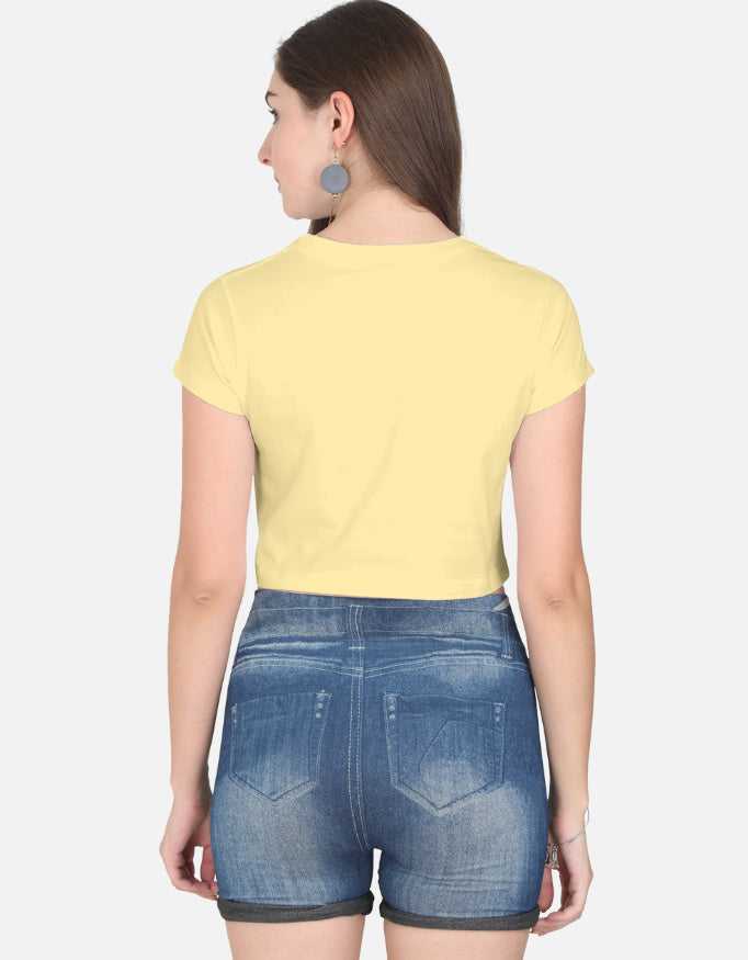 Back view of women wearing yellow crop top with denim shorts